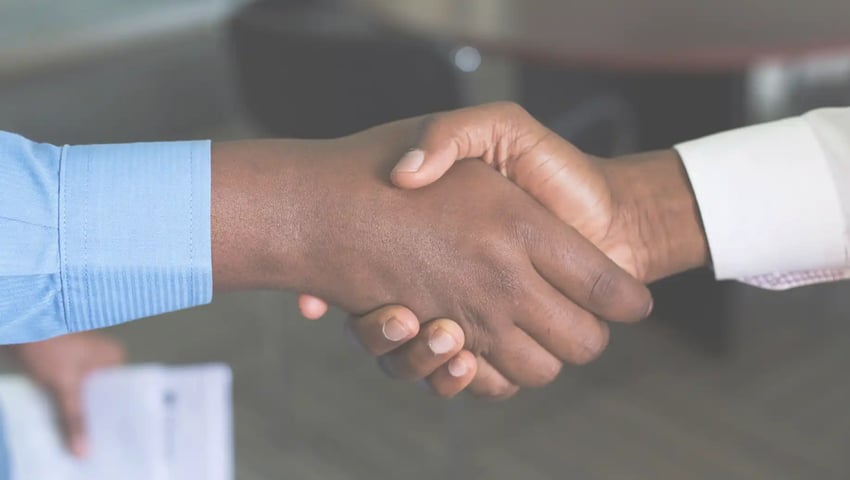 How to make meaningful client connections and earn customers for life - two person handshaking