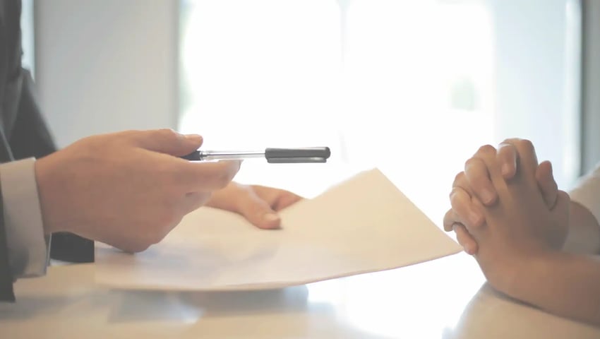 Insurance agent giving contract to a client to sign - Sell more life insurance by getting into your customer's mindset